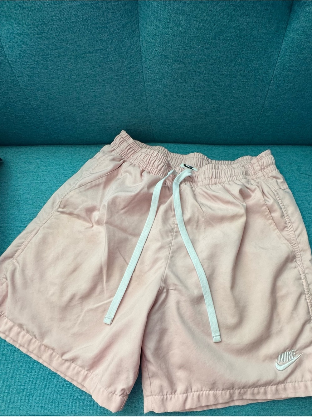 Nike Men’s Light Pink Elastic Drawstring swim trunks.